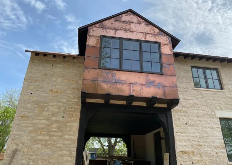 Copper metal panel facade on a stone building for Skylight Installation in Dodgeville