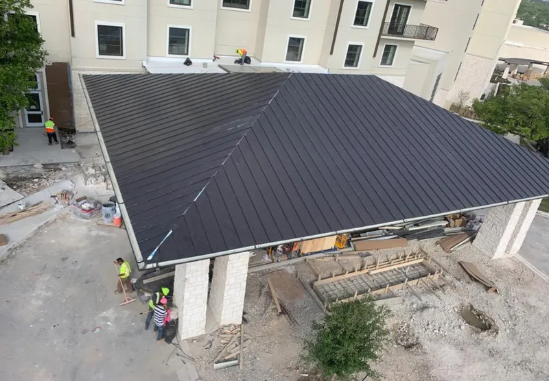 Metal roofing installation team working on a commercial building in Dodgeville